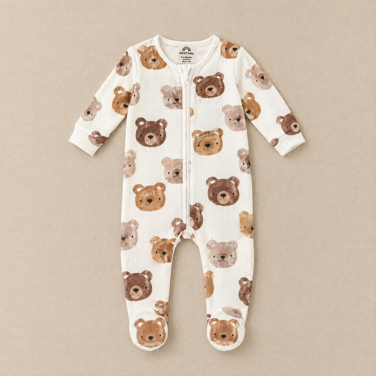 Cream watercolour bear footed sleepsuit, front, laid flat