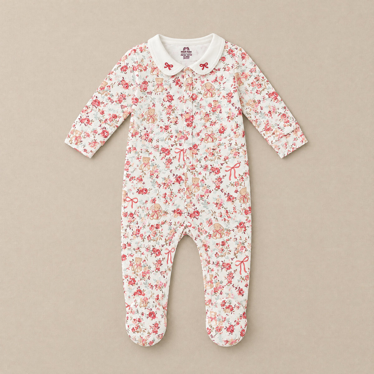 Ivory floral footed sleepsuit with bow-embroidered collar, front, laid flat