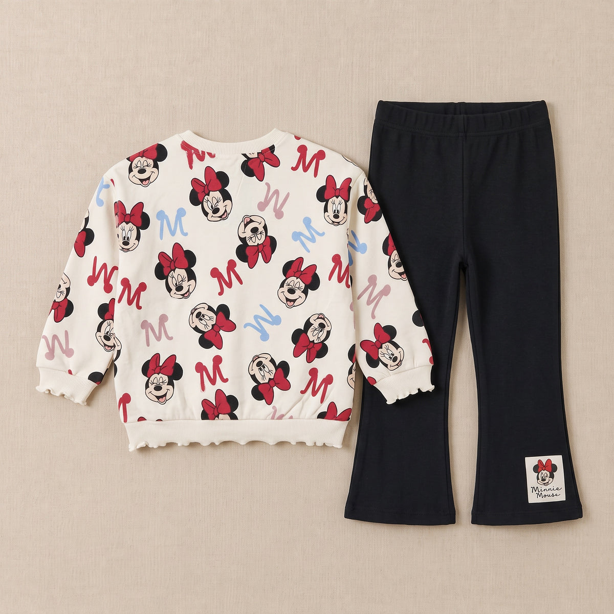 Mouse print sweatshirt and black flared trousers laid flat, back