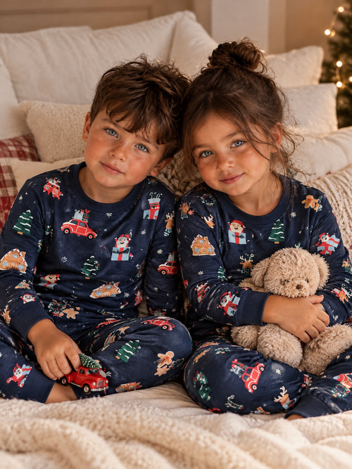 Two children playing in the navy Christmas print T-shirt and joggers set
