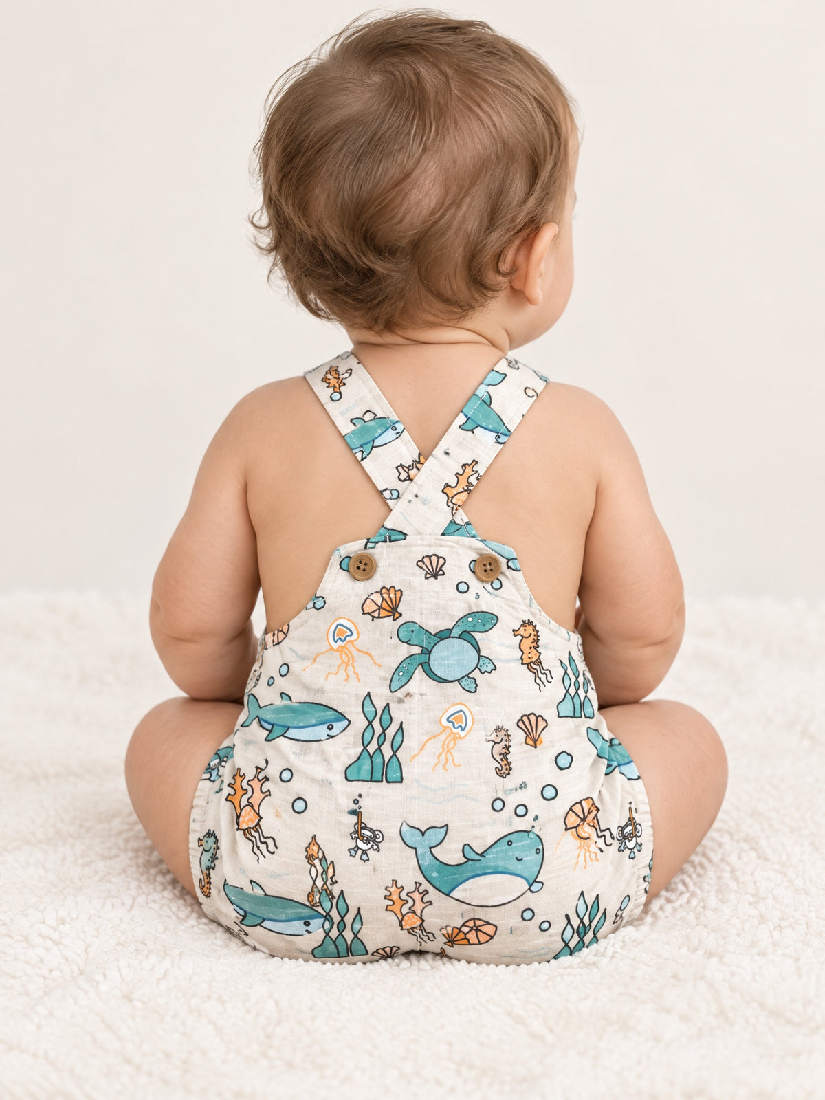 Baby in the Under the Sea dungarees, back with crossed straps