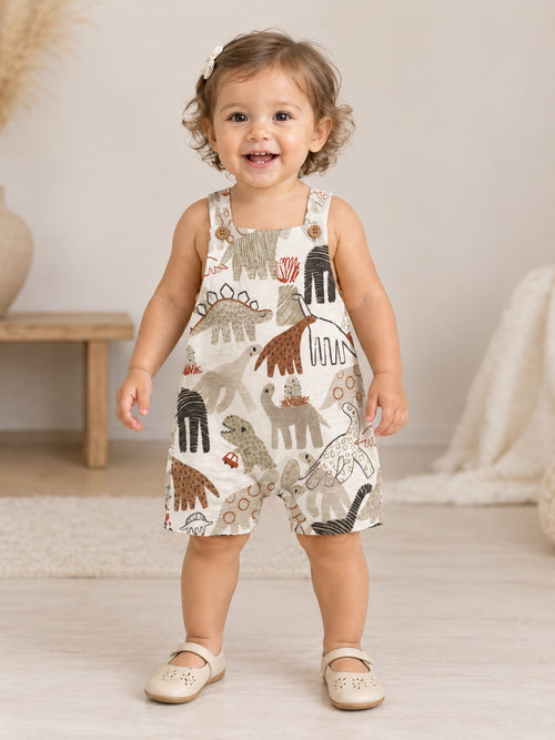 Toddler standing in the Dino Parade dungarees, front