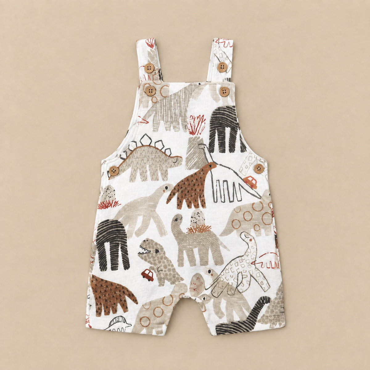 Dino Parade dungarees laid flat