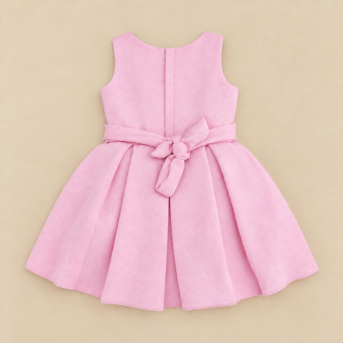 Back of the pink frock laid flat, with the tie sash