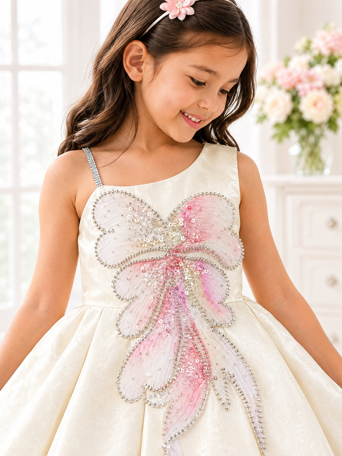 Close-up of the beaded, sequinned tulle butterfly and rhinestone strap