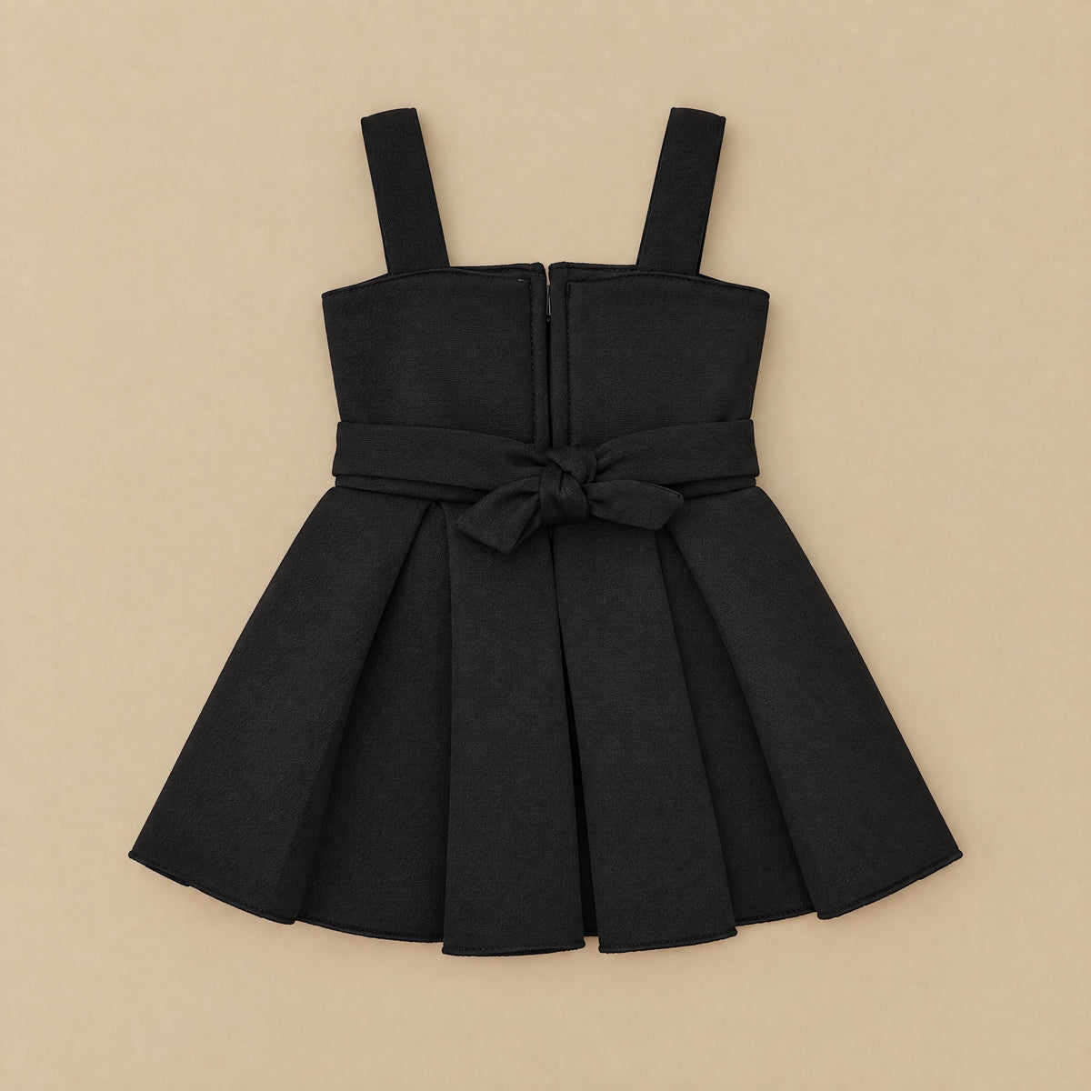 Back of the black rose dress laid flat, with zip and tie sash