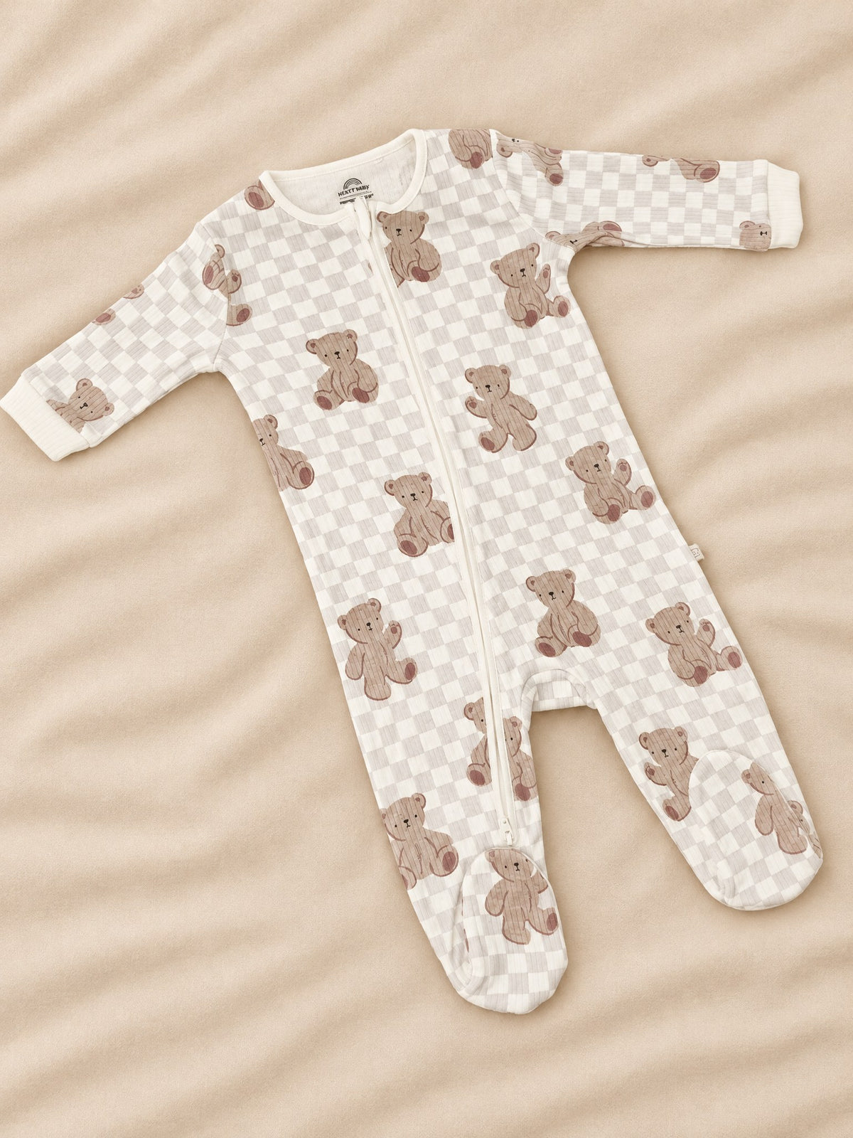 Bear checkerboard footed sleepsuit in cream, front, laid flat