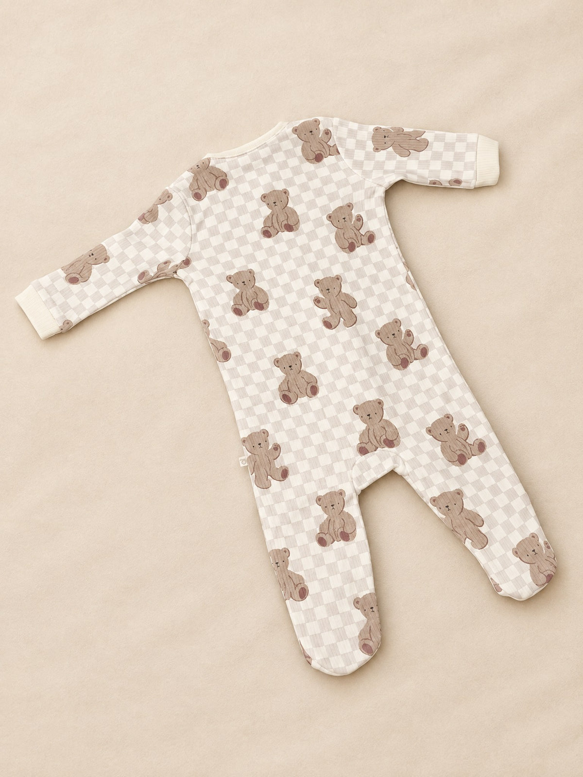 Bear checkerboard footed sleepsuit in cream, back, laid flat