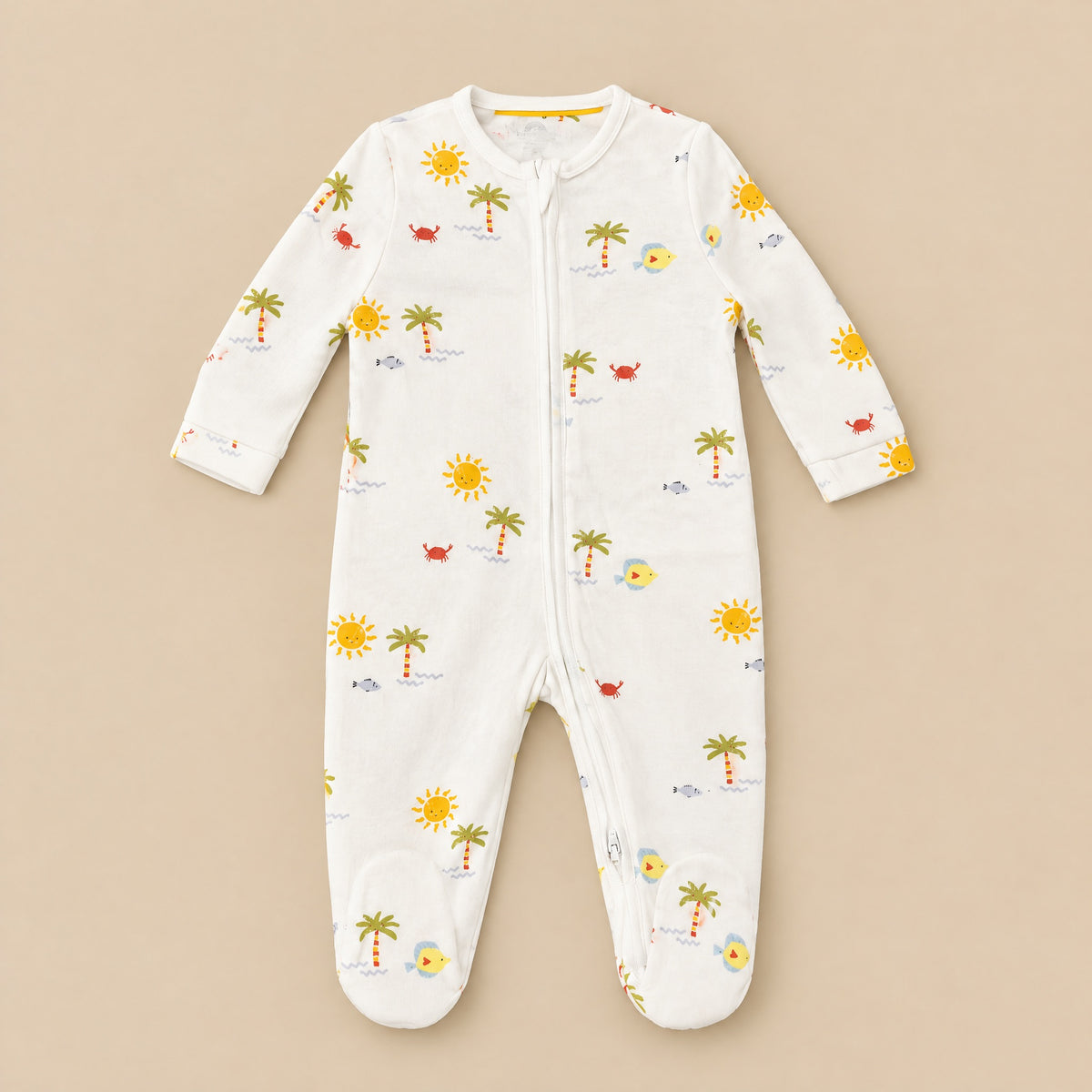 Front of the cream tropical-print footed sleepsuit laid flat, full-length zip